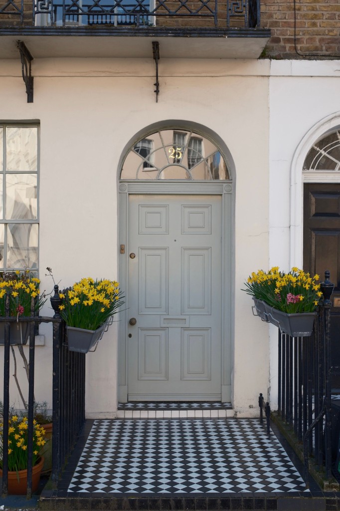Sage green wooden front door with fanlight, brass fittings and checkered tiled entrance - door installation by Ikveles Construction