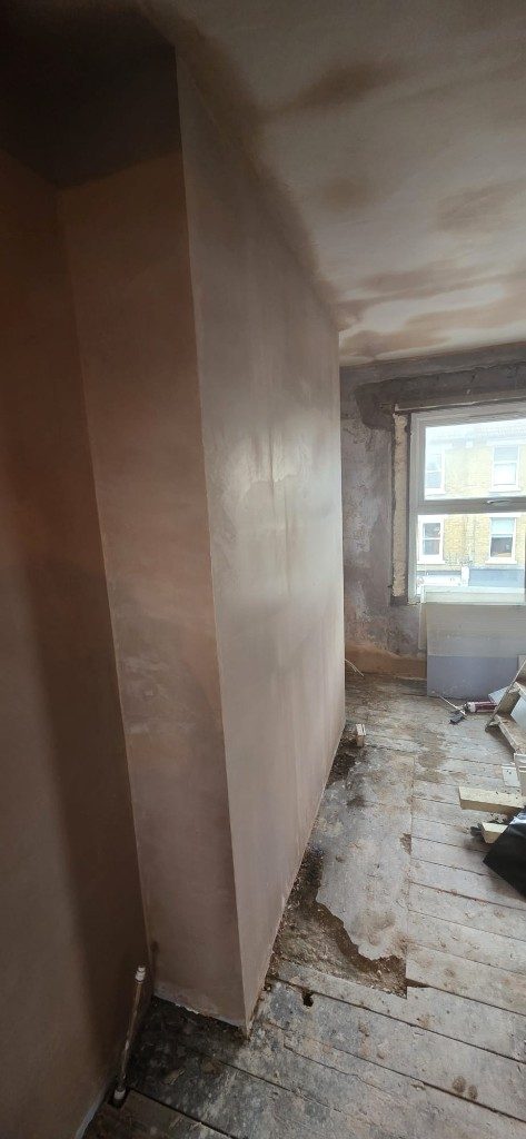 Fresh plaster on walls and ceiling during room renovation by Ikveles Construction