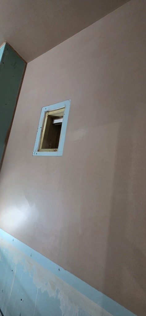 High-quality skim coat plaster finish on an interior wall by Ikveles Construction