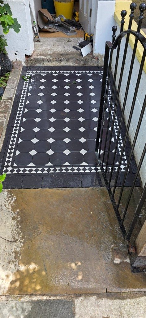 Victorian-style outdoor path tiling with black octagon tiles and white diamond accents by Ikveles Construction